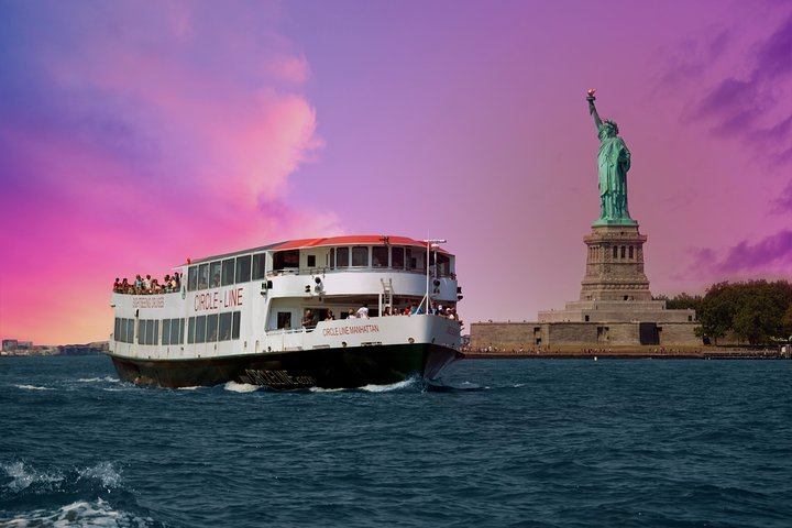 Experience the magic of New York City as you glide past iconic landmarks on the Harbor Lights Cruise enjoying stunning views and delightful commentary under a beautiful twilight sky.